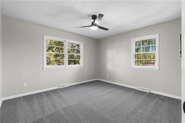 empty room featuring a textured ceiling, carpet flooring, and ceiling fan