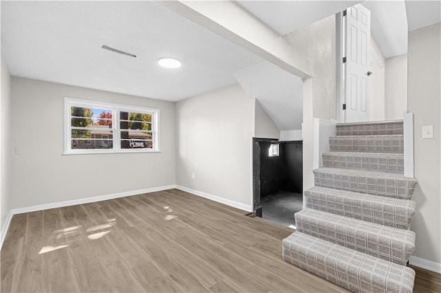 stairs featuring hardwood / wood-style flooring