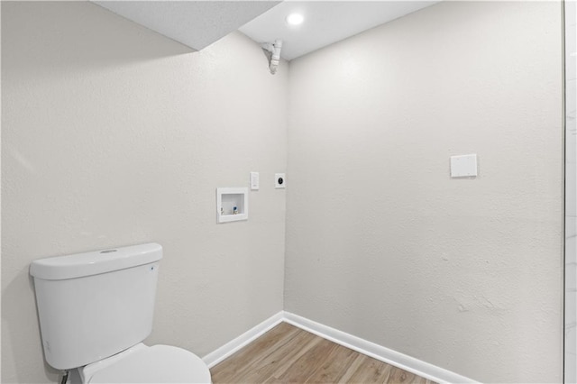 bathroom with toilet and hardwood / wood-style flooring