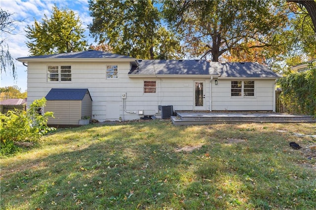 back of property featuring a yard and a shed