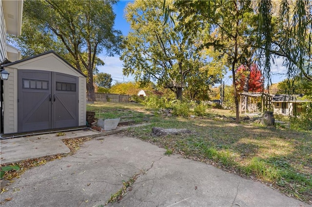 view of yard with a patio and a storage shed