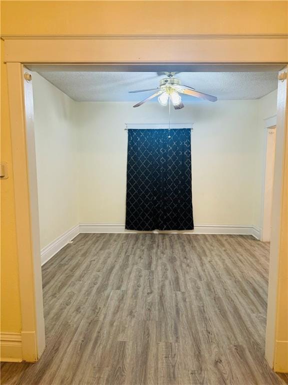 unfurnished room with hardwood / wood-style floors, a textured ceiling, and ceiling fan