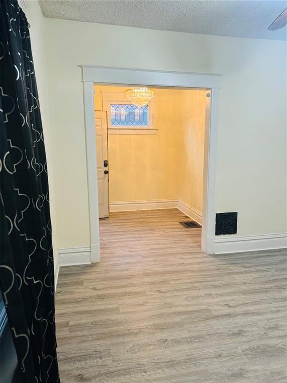 interior space with wood-type flooring and a textured ceiling