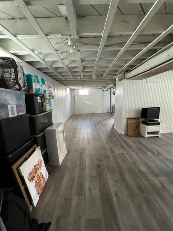 basement with hardwood / wood-style flooring and ceiling fan