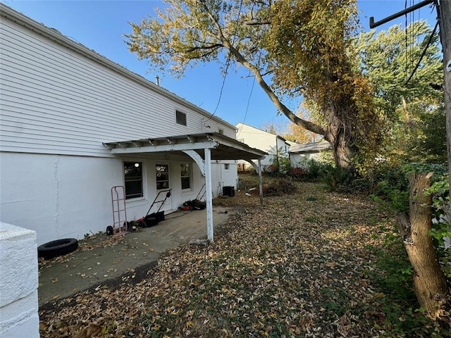 view of yard with central AC and a patio area