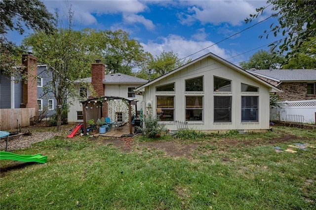 rear view of house featuring a yard