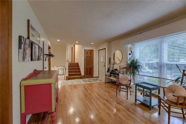 interior space featuring light hardwood / wood-style floors and a textured ceiling