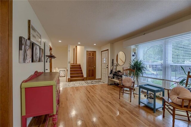 320 Jones Ave, Warrensburg, MO 64093 - foyer with stairway, light wood-type flooring, and recessed lighting
