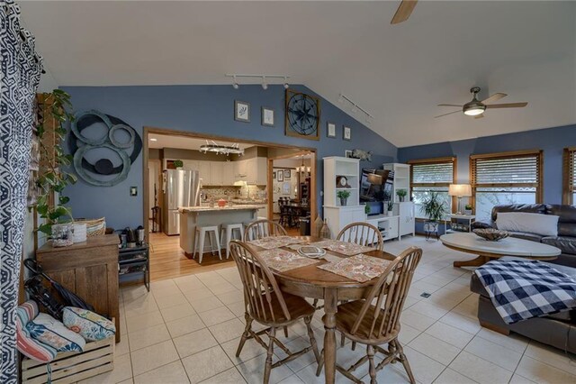 320 Jones Ave, Warrensburg, MO 64093 - dining room featuring ceiling fan, light tile patterned floors, high vaulted ceiling, and track lighting