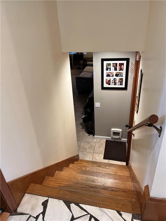 stairway with tile patterned floors