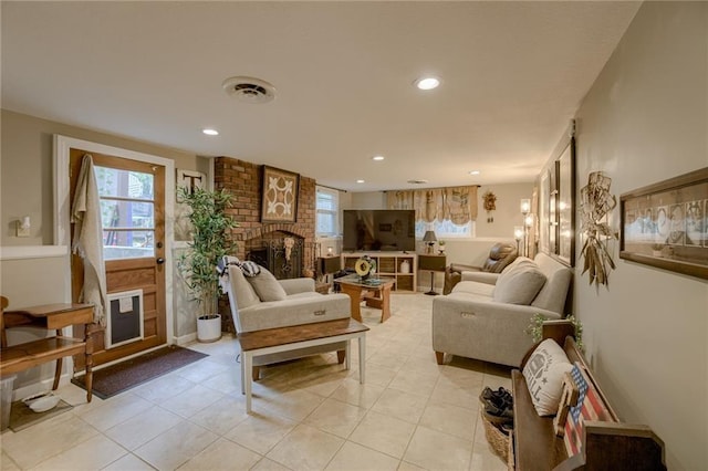 tiled living room with a brick fireplace