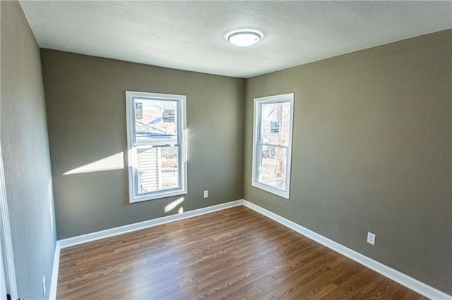 unfurnished room featuring hardwood / wood-style floors and a wealth of natural light