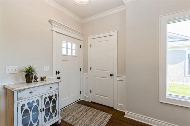 foyer entrance with dark wood-type flooring, ornamental molding, and plenty of natural light