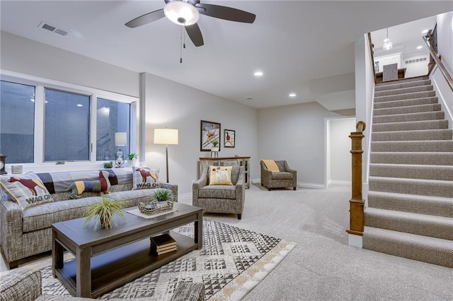 living area featuring recessed lighting, stairway, a ceiling fan, visible vents, and carpet