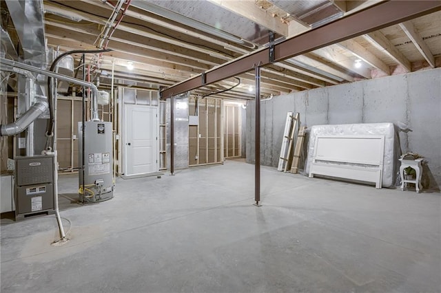 unfinished basement with heating unit and gas water heater