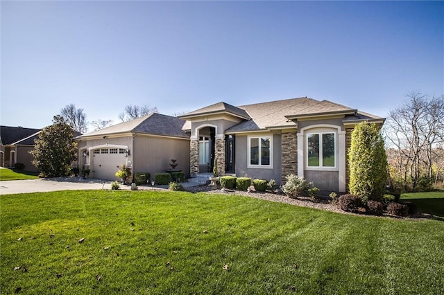 view of front of property with a front yard and a garage