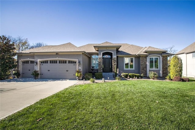 view of front of home with a front lawn and a garage