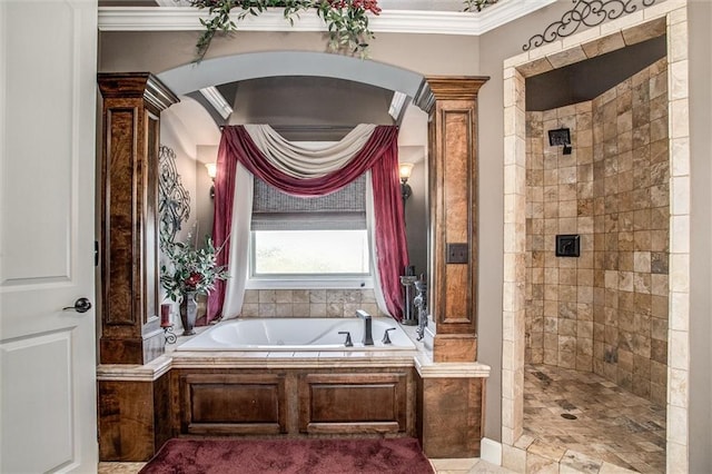 bathroom featuring separate shower and tub, ornamental molding, and decorative columns