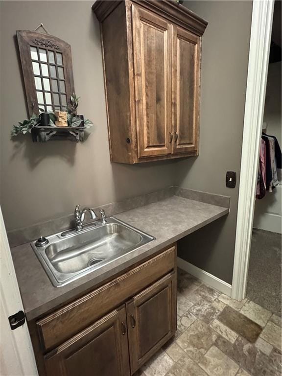 kitchen featuring dark brown cabinetry and sink