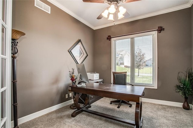 carpeted home office with ceiling fan and ornamental molding