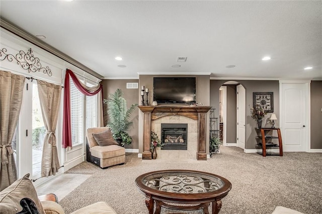 living room featuring a fireplace, light colored carpet, and crown molding