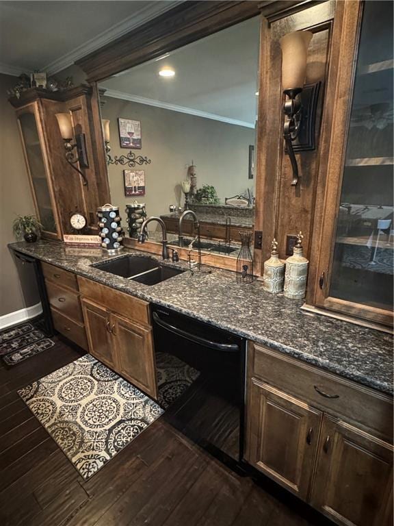 interior space with dark wood-type flooring, dark stone counters, crown molding, sink, and black dishwasher