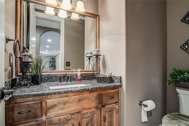 bathroom featuring vanity and toilet