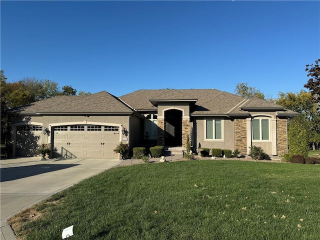 view of front of property featuring a garage and a front lawn