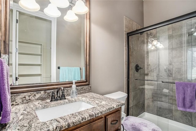 full bath with toilet, a shower stall, and vanity