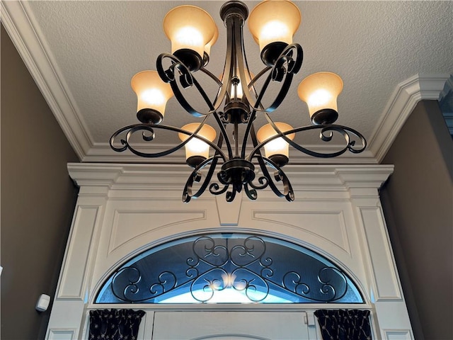 interior details with ornamental molding and a notable chandelier