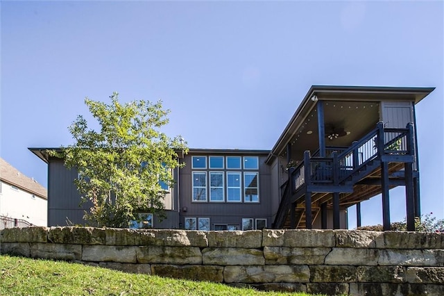 rear view of house with stairs and a deck