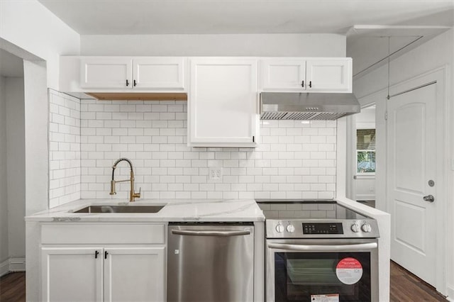 kitchen featuring white cabinets, dark hardwood / wood-style floors, sink, range hood, and stainless steel appliances