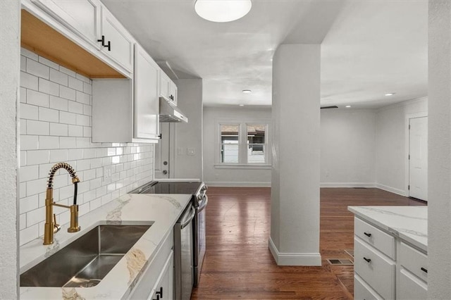 kitchen featuring sink, light stone countertops, electric range, white cabinetry, and dark hardwood / wood-style flooring