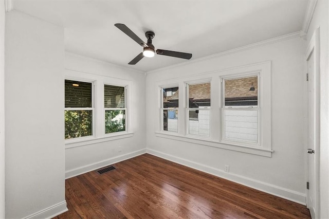 spare room with ornamental molding, dark wood-type flooring, and ceiling fan