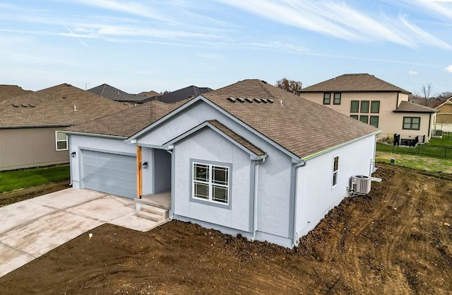 view of front facade featuring central AC unit and a garage