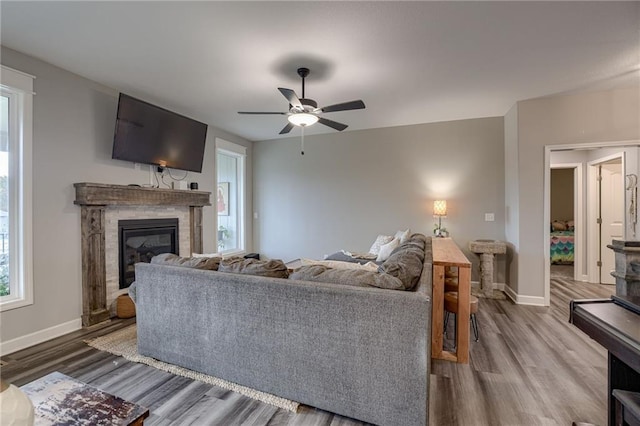 living room with wood-type flooring and ceiling fan