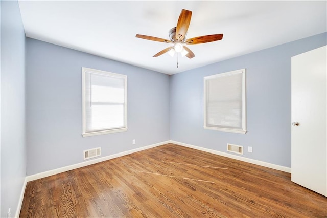 spare room featuring hardwood / wood-style floors and ceiling fan