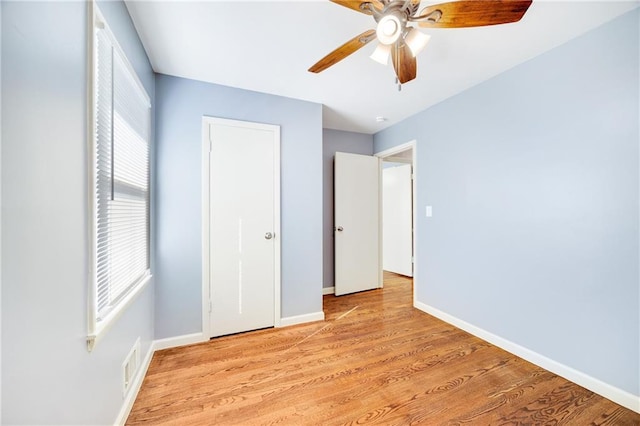 unfurnished bedroom with ceiling fan and light hardwood / wood-style flooring