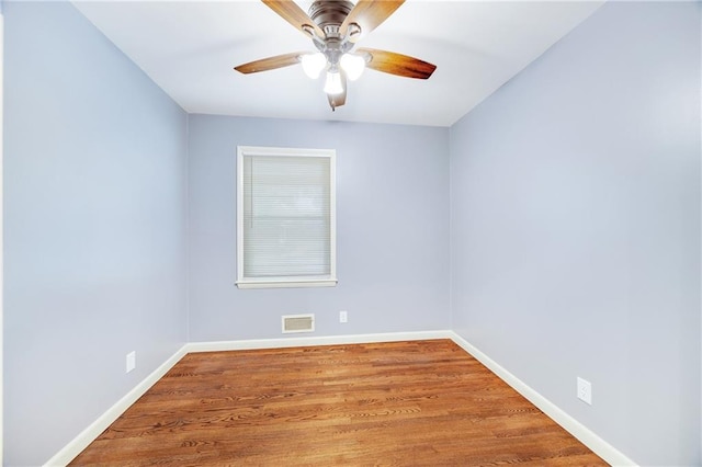 spare room with hardwood / wood-style floors and ceiling fan