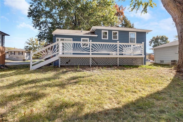 back of property featuring a lawn and a wooden deck