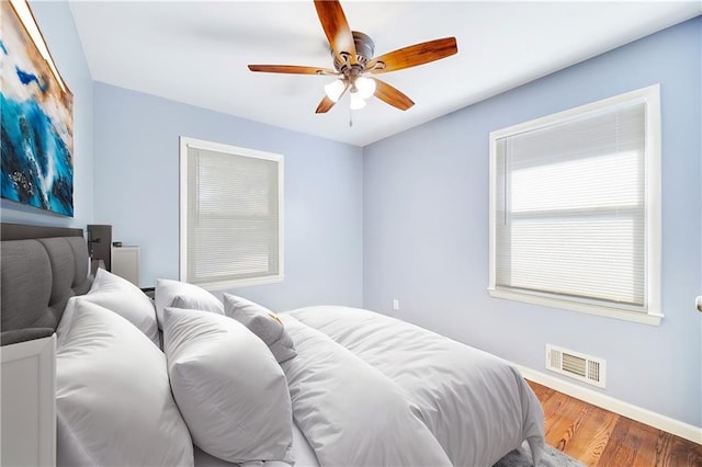 bedroom featuring hardwood / wood-style flooring and ceiling fan