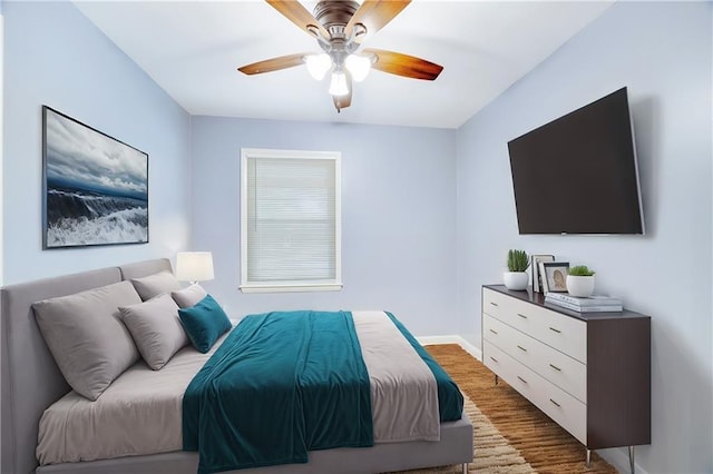 bedroom with dark wood-type flooring and ceiling fan