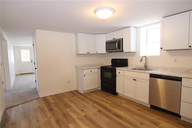 kitchen with white cabinetry, appliances with stainless steel finishes, sink, and a wealth of natural light