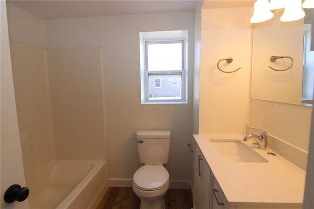 bathroom featuring vanity, hardwood / wood-style flooring, and toilet