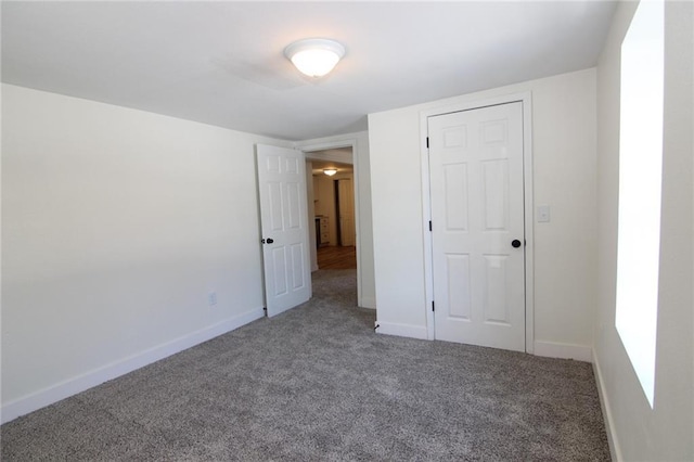 unfurnished bedroom featuring a closet and carpet