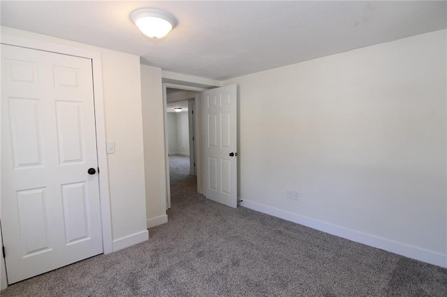 unfurnished bedroom featuring light colored carpet and a closet