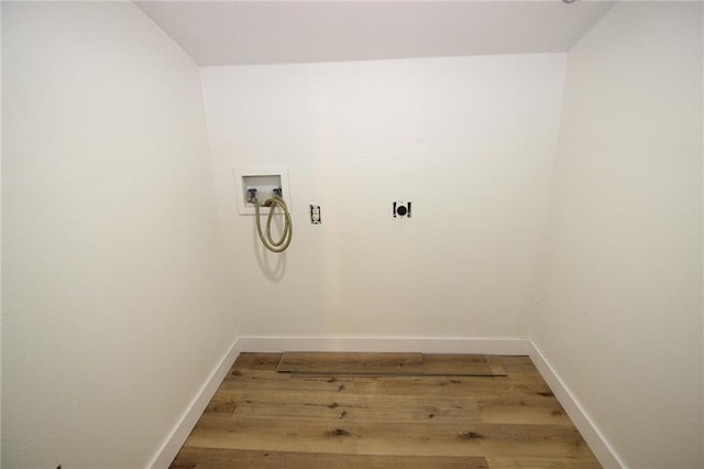 laundry area with hookup for a washing machine, hookup for an electric dryer, and hardwood / wood-style flooring