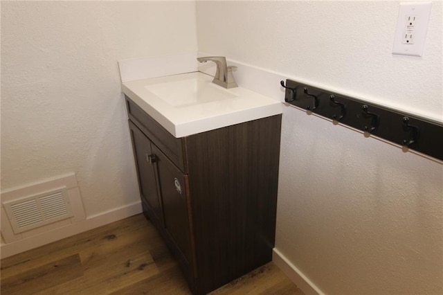 bathroom featuring vanity and hardwood / wood-style floors