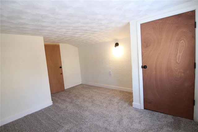 carpeted empty room with a textured ceiling