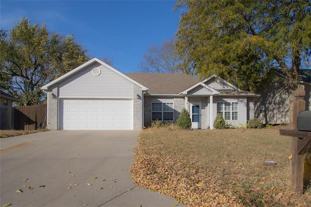 ranch-style home with a front lawn and a garage